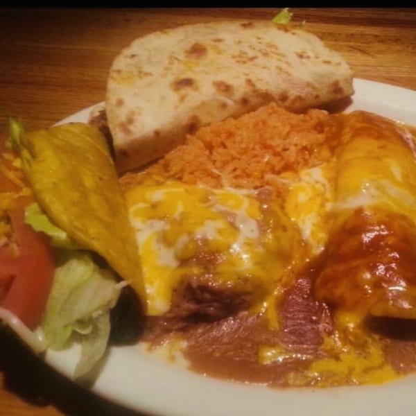 A Kico's Mexican Food combo plate with a taco, enchiladas, rice, beans, and a quesadilla.