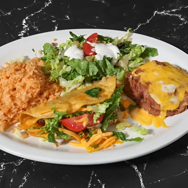 Kico's Mexican Food combo plate with a taco, rice, refried beans with cheese, and salad.